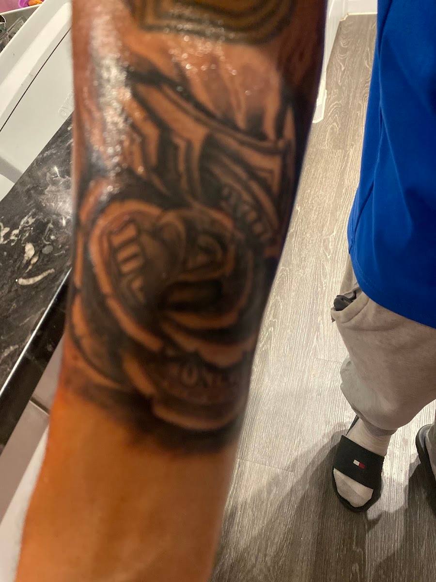 Black and gray shaded tattoo on an arm