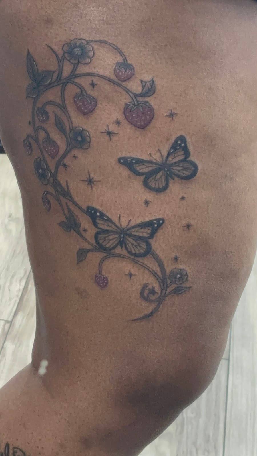 Black butterfly and vine tattoo