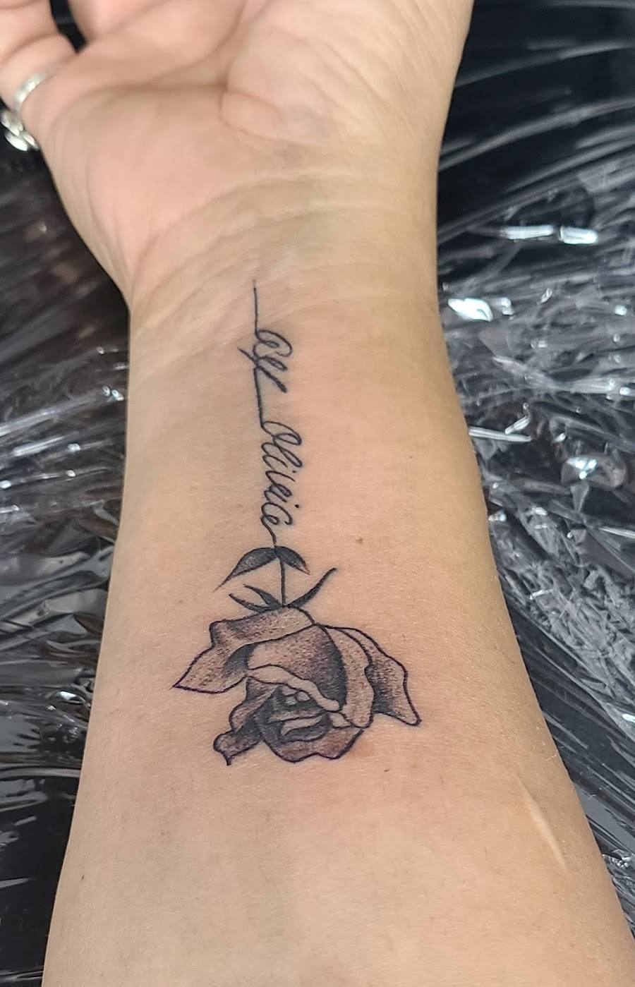 Fine line floral tattoo on a forearm